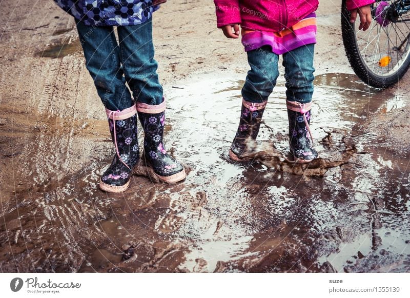 human children Joy Leisure and hobbies Playing Child Human being Infancy Legs Feet Earth Autumn Weather Bad weather Rain Fashion Clothing Pants Footwear