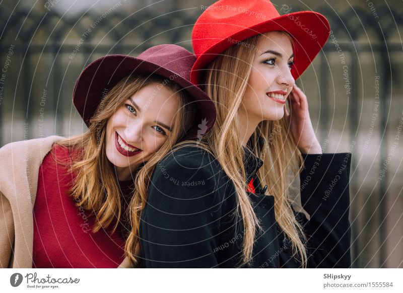 Two girls sitting on the bench and smile Lifestyle Joy Happy Beautiful Face Meeting To talk Human being Feminine Woman Adults Friendship Teeth Autumn Fashion