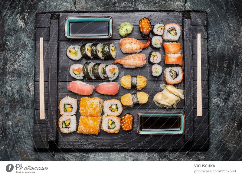 Sushi served on a dark wooden plate Food Fish Grain Herbs and spices Nutrition Lunch Dinner Asian Food Style Healthy Eating Table Restaurant Design Lemur nigiri