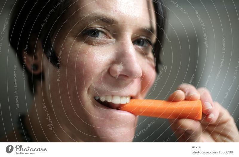 Smiling woman eating carrot Vegetable Carrot Nutrition Eating Organic produce Vegetarian diet Finger food Healthy Healthy Eating Woman Adults Life Face 1
