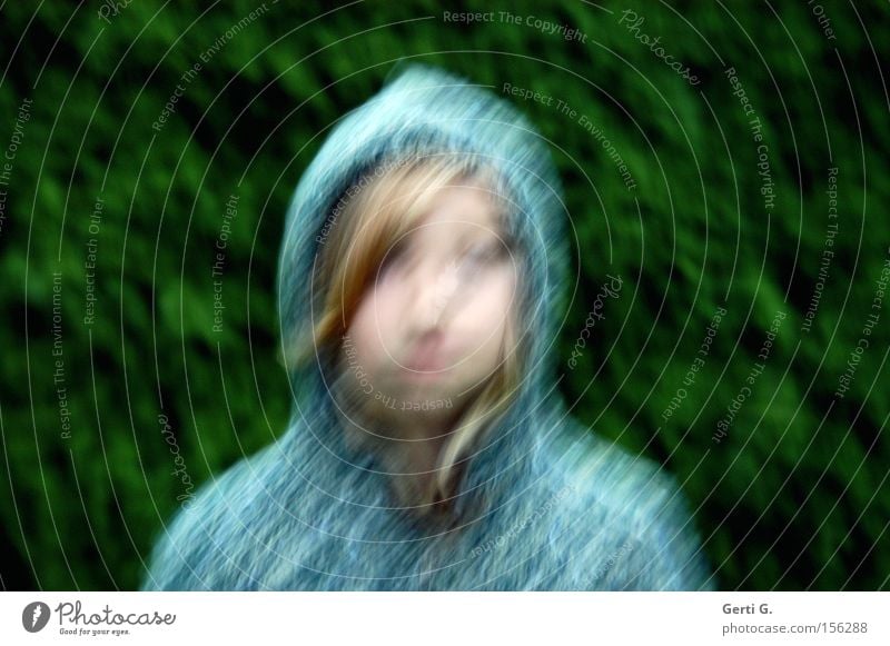 bemused Girl Face Hooded (clothing) Cardigan Blur Blonde Green Blue Wind Fir tree Child Emotions Crazy Distorted Muddled Hair and hairstyles Sadness Irritation