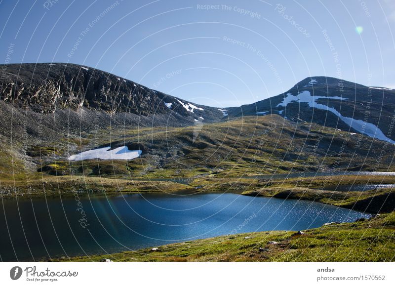 Lonely lake in Norway in the mountains Lake Empty Deserted Mountain nothing going on Snow rock stones Stone Nature Landscape Scandinavia Hiking Rondane