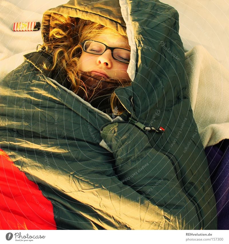 Woman sleeps in sleeping bag Sleep Relaxation Sleeping bag Cold Calm Human being Packaged Peace Trust Camping Lie Peaceful Exterior shot Eyeglasses outdoor