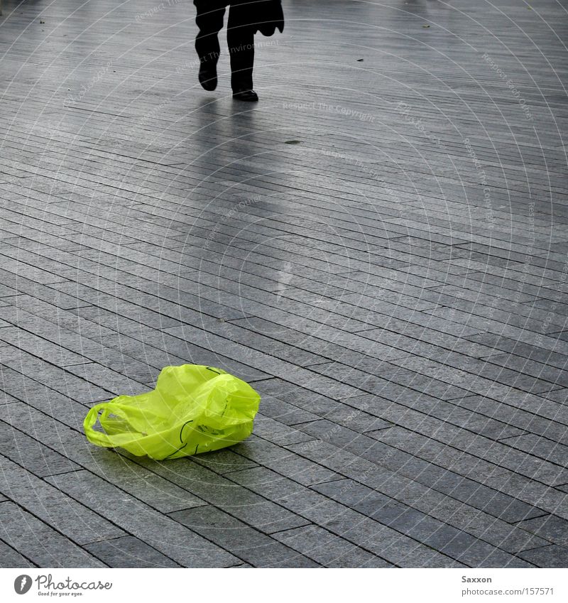 The green bag Promenade Sidewalk Footpath Green Paper bag Trash Recycling Commute Patch of colour Gloomy Loneliness Traffic infrastructure Paving stone Haste