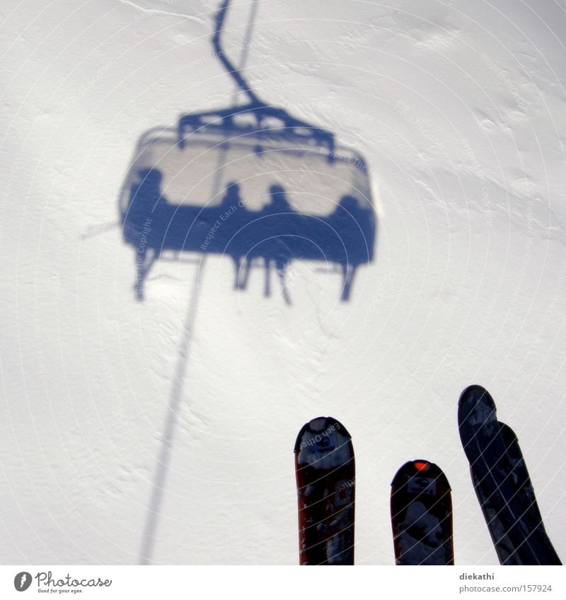 on the air Skiing Skis Snow Shadow White Chair lift Ski lift Human being Mountain Austria Ischgl Air Height Winter Winter sports Skilift chair Bright background