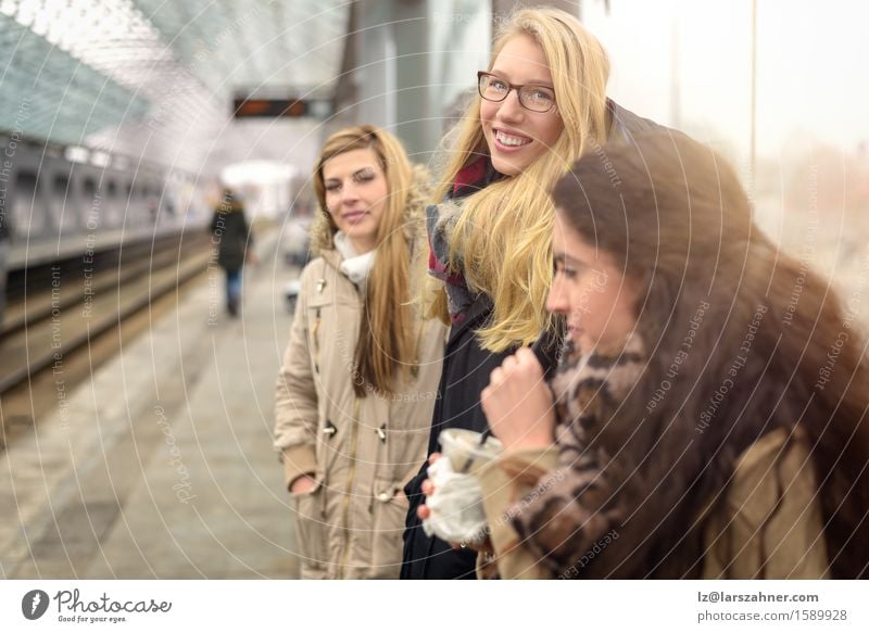Atttractive young women waiting for train Happy Face Winter Woman Adults Friendship 3 Human being 18 - 30 years Youth (Young adults) Public transit Brunette