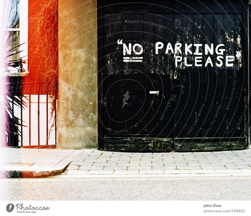 Polite parking ban. Garage Garage door Parking area Facade Traffic infrastructure Characters Signage Warning sign Graffiti Friendliness Black Bans Clearway