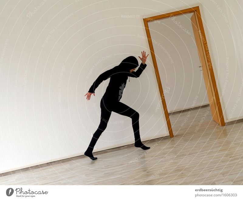 Ascent - person walking uphill; illusion due to slight tilting of the image Human being Wall (barrier) Wall (building) Tights Hooded sweater Walking Black White