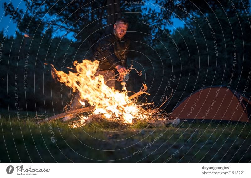 Man lights a fire in the fireplace in nature at night Leisure and hobbies Vacation & Travel Tourism Adventure Camping Summer Mountain Hiking Human being Adults