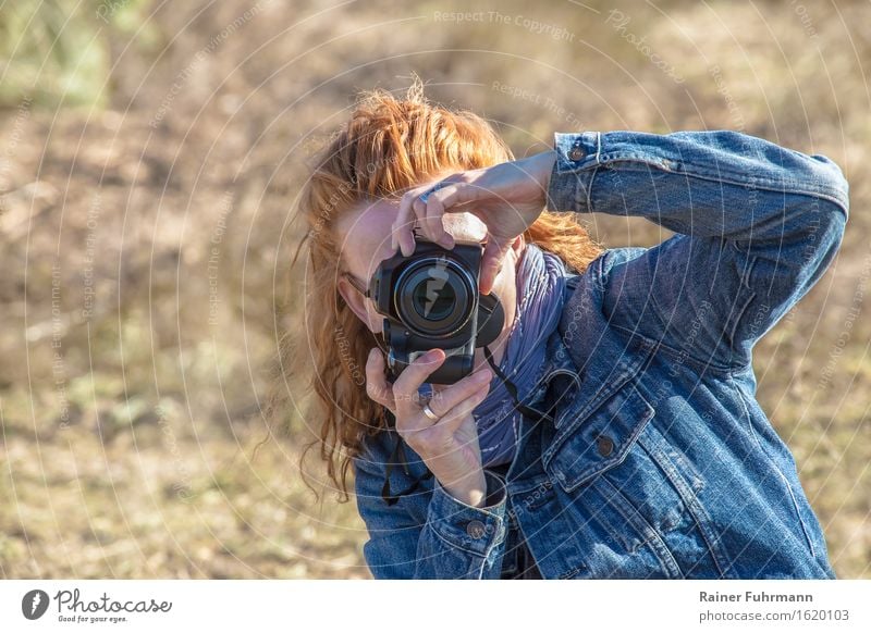 a woman quickly shoots some illegal photos Human being Feminine Woman Adults 1 Beautiful weather Red-haired Experience Communicate Surveillance Advertising