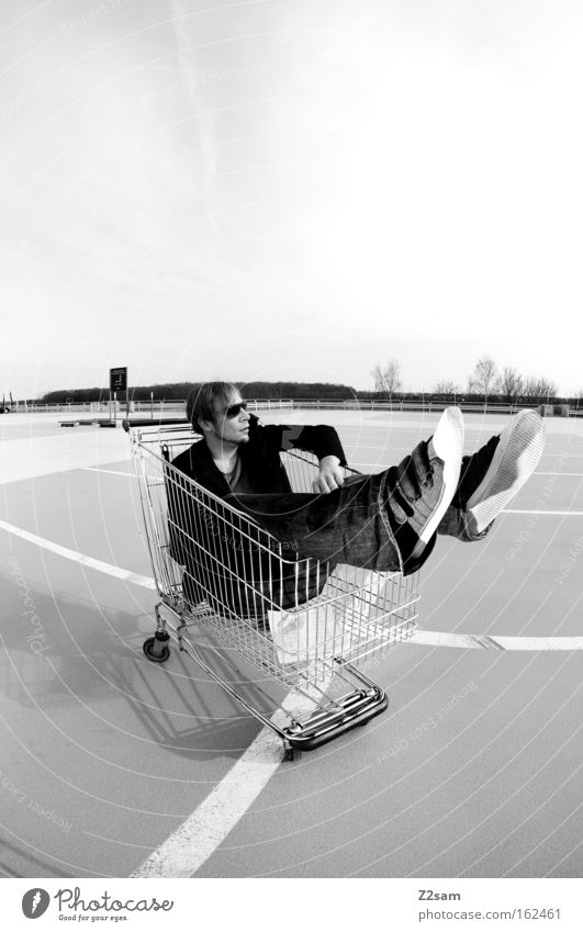 special offer Human being Man Easygoing Cool (slang) Parking lot Shopping Trolley Black & white photo Sit Line