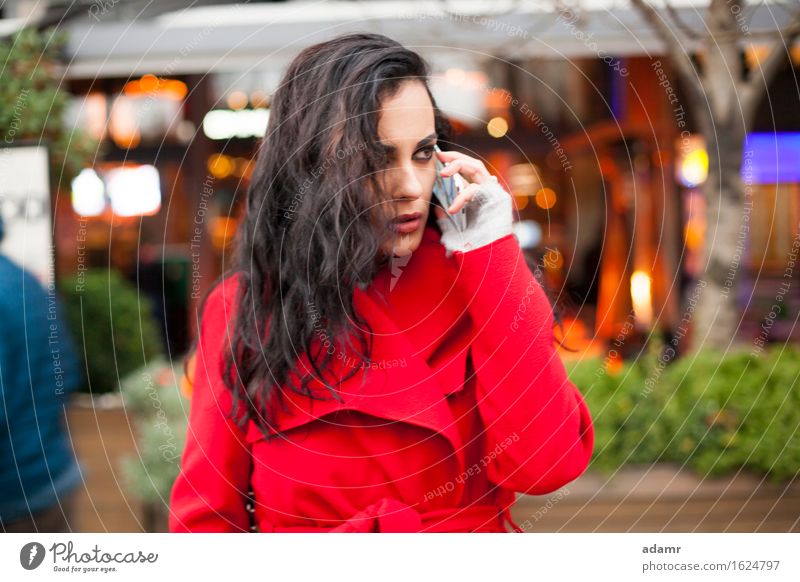 Woman in red coat speak on mobile phone woman woriew looking smartphone person cold winter female telephone cell communication people wireless cellphone hand