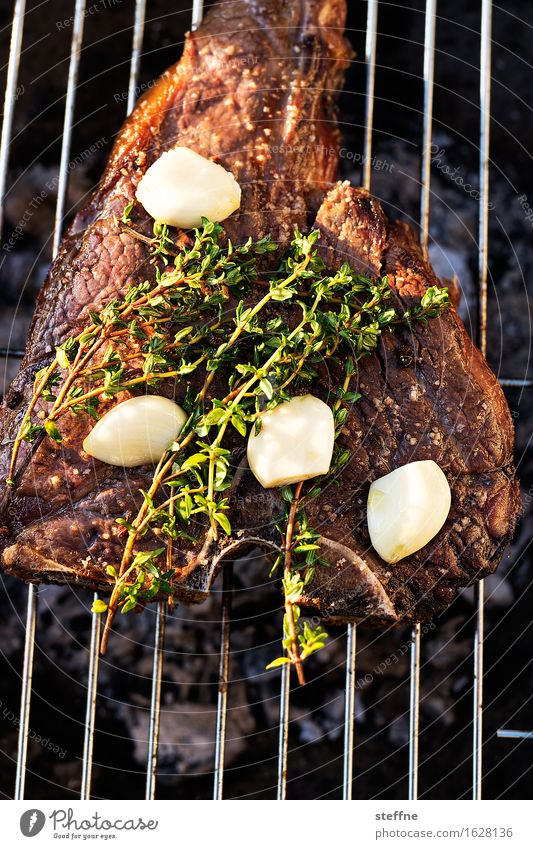 barbecue evening Food Meat Nutrition Banquet Hip & trendy Steak dry aged t-bone Barbecue (event) Garlic Thyme Colour photo Exterior shot Copy Space bottom