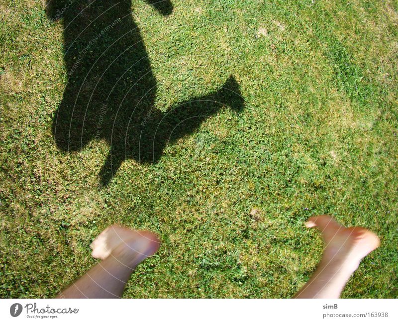 I can fly Colour photo Exterior shot Day Shadow Sunlight Motion blur Bird's-eye view Downward Happy Grass Movement Jump Green space Feet Ground