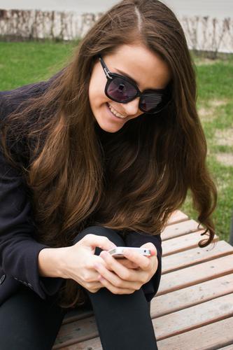 Beautiful business woman with cell phone is laughing Lifestyle Style Joy Business SME Cellphone Young woman Youth (Young adults) 1 Human being 18 - 30 years