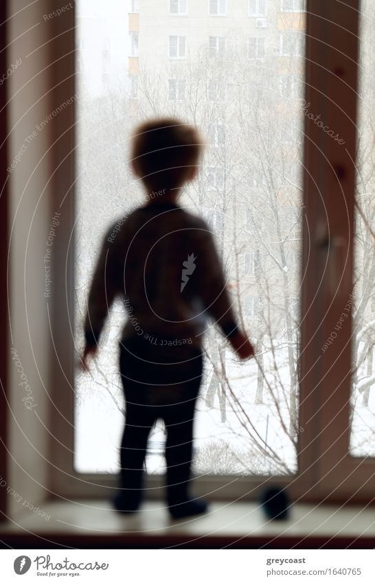 Boy stands on the windowsill and looking through the window. Winter Child Baby Toddler Boy (child) Infancy Body 1 Human being 1 - 3 years Weather Think Stand