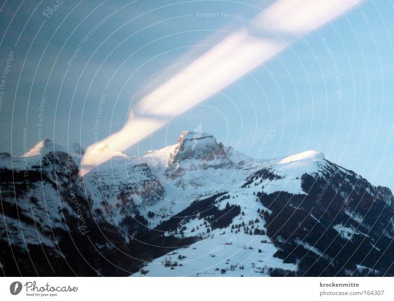 UFO SIGHTING IN SWITZERLAND? Colour photo Exterior shot Morning Light Sunlight Sunbeam Nature Landscape Elements Alps Mountain Peak Snowcapped peak Stone Blue