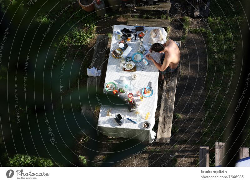View from above of a garden table set in summer, at which a young man is sitting Relaxation Leisure and hobbies Table Eating BBQ season Young man