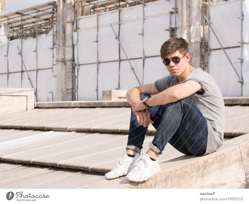 He sits Masculine Young man Youth (Young adults) Brother 1 Human being 13 - 18 years Fashion T-shirt Jeans Sunglasses Sneakers Observe Crouch Free Athletic