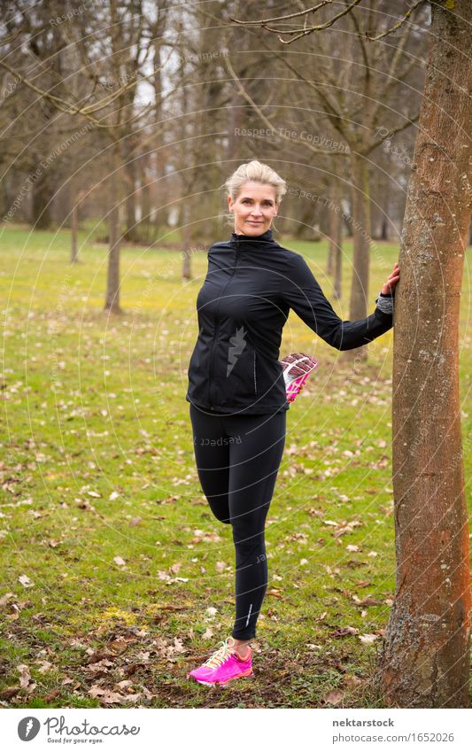 woman stretching in park Lifestyle Body Wellness Sports Human being Woman Adults Park Fitness Smiling Stand Athletic Thin Friendliness limbering up Musculature