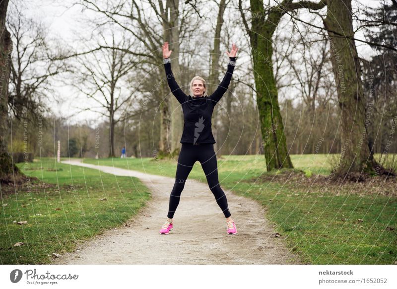 woman exercising on winter day Lifestyle Joy Happy Body Wellness Sports Human being Woman Adults Arm Tree Park Fitness Smiling Jump Athletic Practice healthy