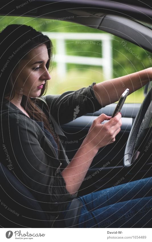 Mobile phone at the wheel Woman youthful car Motoring peril distracted perilous SMS whatsapp news underestimated Typing Looking away Risk hands Steering wheel