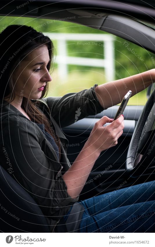 young woman using a cell phone at the wheel of her car Cellphone Car Woman peril interdiction reckless vulnerability Road traffic Motoring distracted