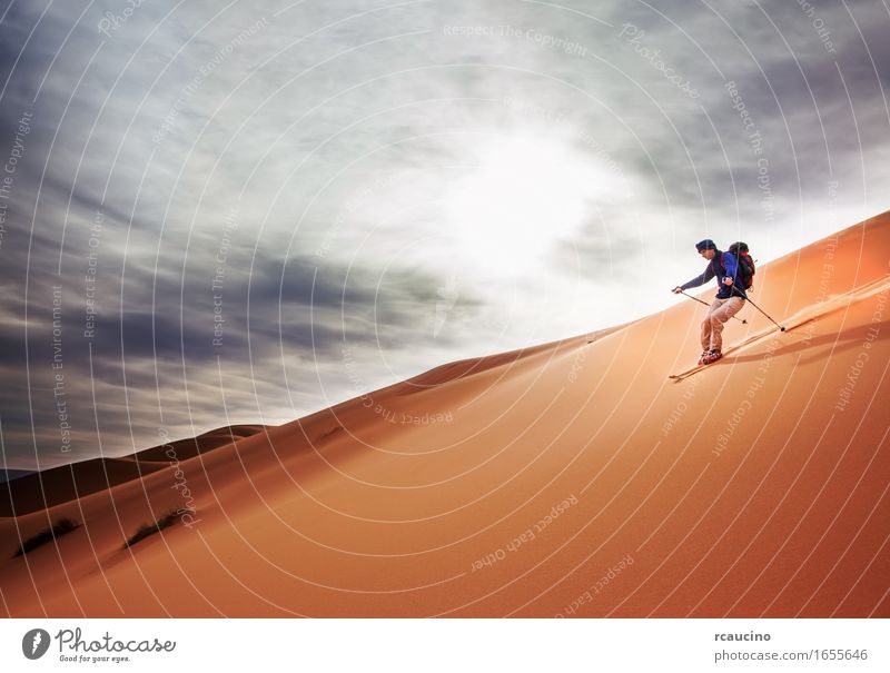 A skier goes downhill on a big sand dune in Sahara desert. Vacation & Travel Trip Adventure Freedom Expedition Hiking Sports Winter sports Skiing Man Adults 1