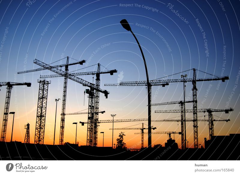 The sun sets and the cranes rise Berlin Germany Europe Manmade structures Site Build Esthetic Sharp-edged Simple Far-off places Gigantic Large New Beautiful