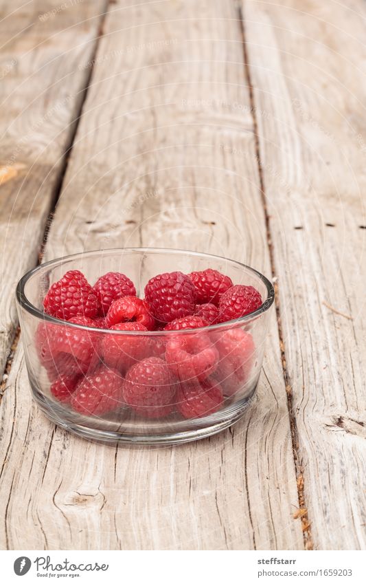 Clear glass bowl of ripe raspberries Food Fruit Nutrition Eating Organic produce Vegetarian diet Diet Plant Wood Glass Pink Red Colour photo Morning Dawn