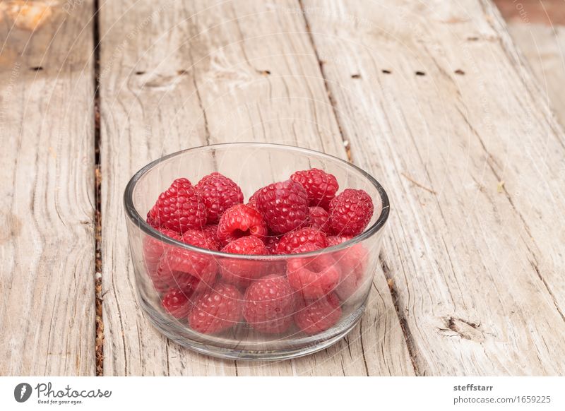 Clear glass bowl of ripe raspberries Food Fruit Nutrition Eating Breakfast Picnic Bowl Glass Beautiful Healthy Plant Diet Pink Red Colour photo Interior shot