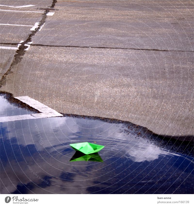 green before grey on blue Colour photo Exterior shot Deserted Day Handicraft Children's game Cruise Waves Water Joy Playing Toys Parking lot Paper boat Green
