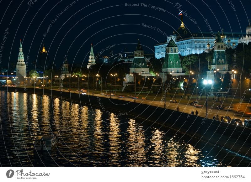 A night view of the Moscow city Kremlin with an illuminated river and a boat. Vacation & Travel Landscape River Town Palace Bridge Building Architecture