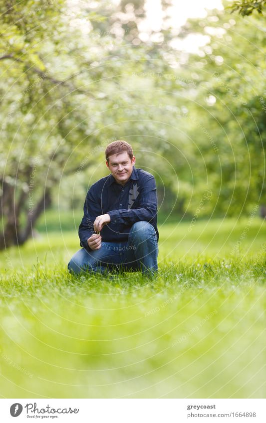 Smiling middle-aged man resting in the city park. Beautiful bokeh background. Lifestyle Happy Relaxation Calm Summer Garden Human being Man Adults 1