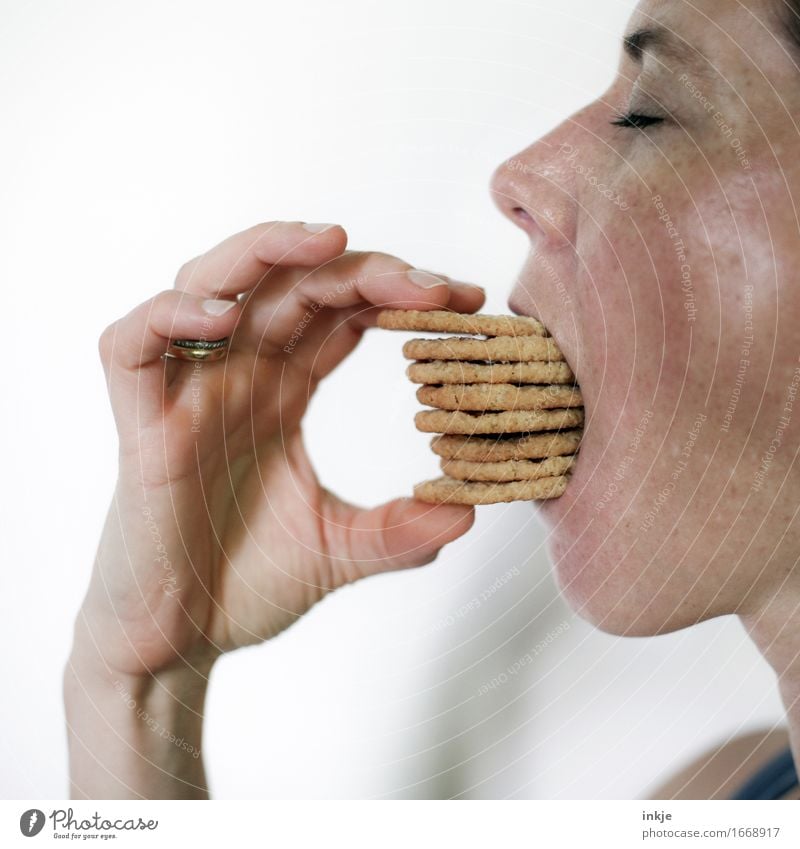 Woman eating a stack of cookies Dough Baked goods Candy Cookie Nutrition Eating Adults Life Face Hand 1 Human being 30 - 45 years To hold on Many Emotions