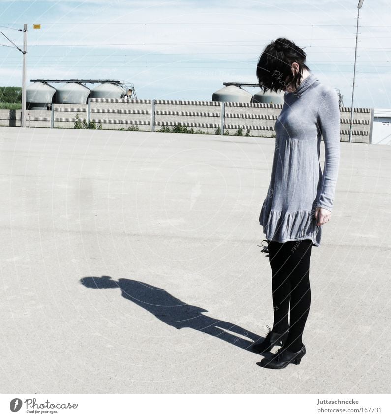 Let one's head hang Woman Young woman Shadow Contrast Sunlight Gray Dress Mini dress Sadness Frustration Loneliness Concrete Places Pallid Subdued colour Grief