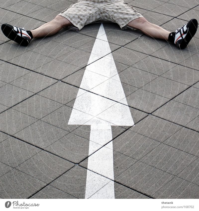 signpost Masculine Man Adults Life Legs Feet 1 Human being Parking garage Sneakers Signs and labeling Sit Wait Joy Checkered Arrow Splay Subdued colour