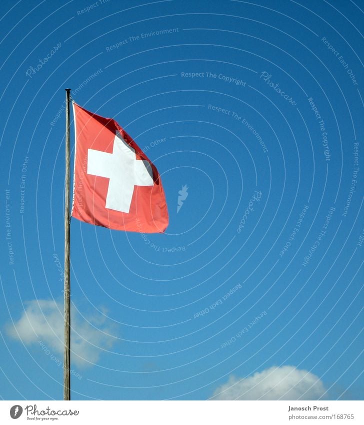 Switzerland in the sky Vacation & Travel Tourism Winter Sky Clouds Beautiful weather Flag Blue Red White Swiss flag Flagpole Sky blue Wind Colour photo