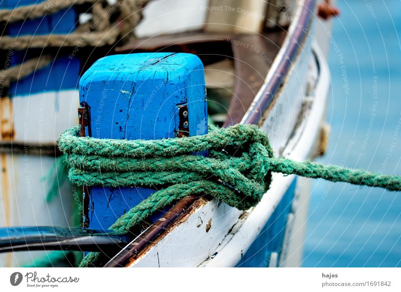 Mooring line of a fish cutter Design Rope Old Illuminate Maritime Blue mooring lines Ship's side Linen anchor lines braided hemp rope Dew text space Copy Space