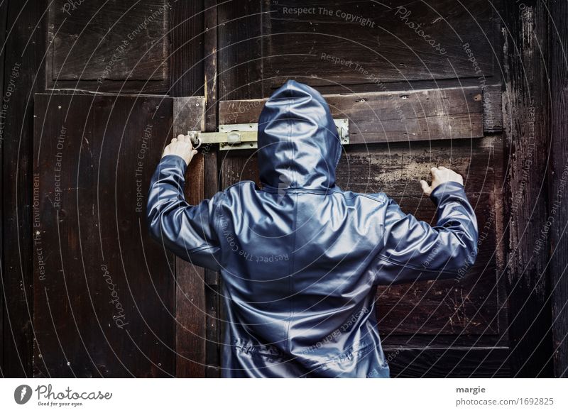 AST 9 | On a secret mission, a person in a coat and hood opens the lock of an old brown wooden door Tool Human being Masculine Feminine Woman Adults Man 1 Wood