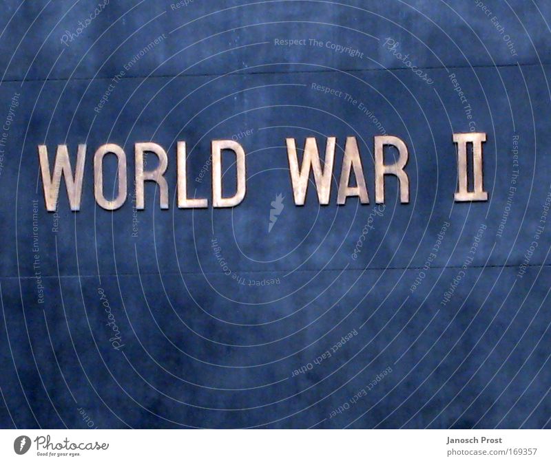 World War II Monument Metal Characters Signs and labeling Historic Blue Brown Silver Honor Past War monument Colour photo Exterior shot Deserted Copy Space top