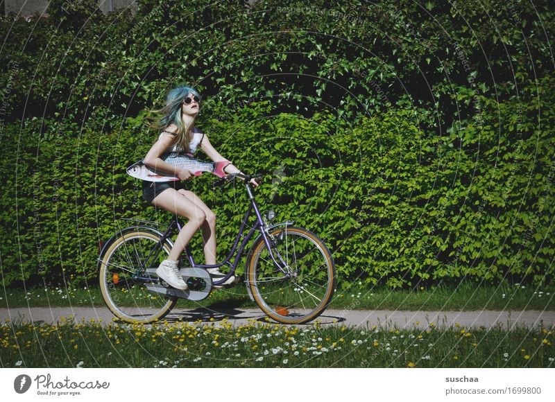 fish & bike Exterior shot Summer Spring Green Bicycle Cycling Child Youth (Young adults) Young woman Girl Wig Fish Whimsical Strange Action Idea Infancy Puberty