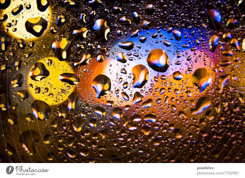 Raindrops at the window Night life Water Drops of water Bad weather Deserted Glass Illuminate Glittering Wet Blue Yellow Orange Light Slice Window pane Blur
