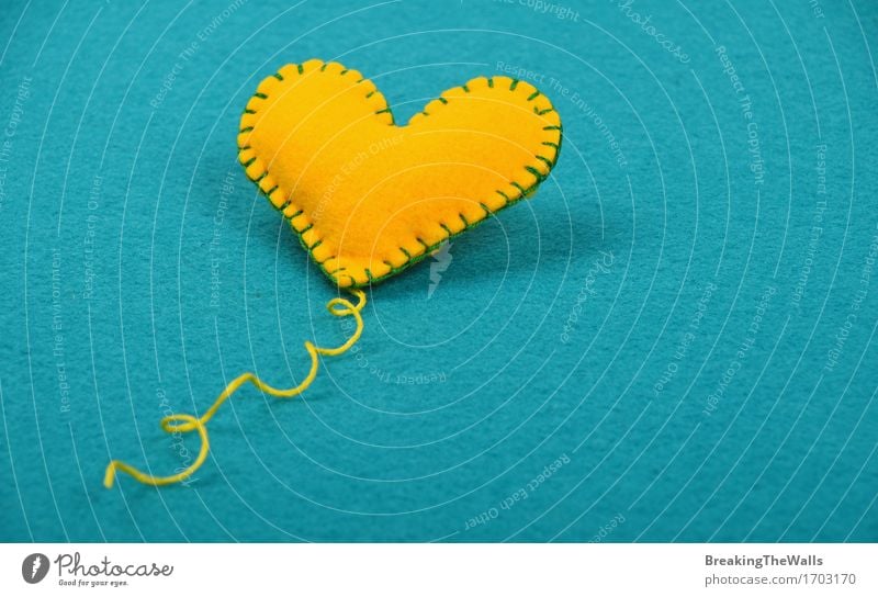 Handmade yellow stitched toy heart with thread on blue felt Lifestyle Design Leisure and hobbies Handicraft Handcrafts Valentine's Day Mother's Day Art
