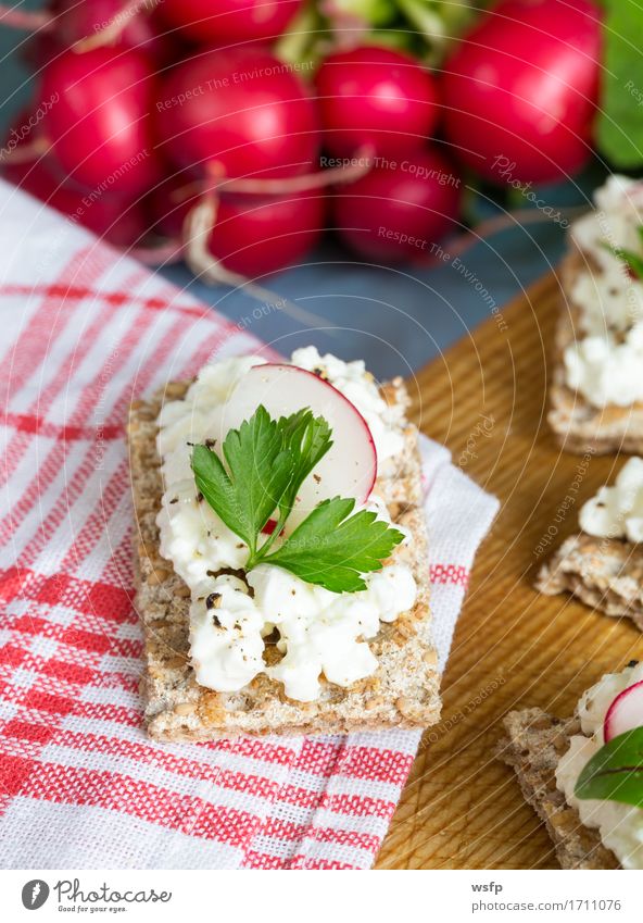 Crispbread with cottage cheese radishes and herbs Herbs and spices Wood Blue Radish Chives Dill Parsley beetroot leaves Wooden board Snack healthy snack vital