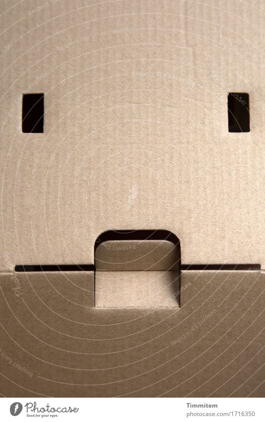 The box hears "Magic." Packaging Line Esthetic Simple Black Emotions Cardboard Listening Meditative Ambience Folds Facial expression Face Colour photo Deserted