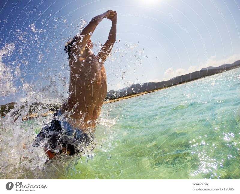 Boy jumping in water, playing and having fun Joy Happy Playing Vacation & Travel Summer Sun Beach Ocean Sports Child Human being Boy (child) Man Adults Nature