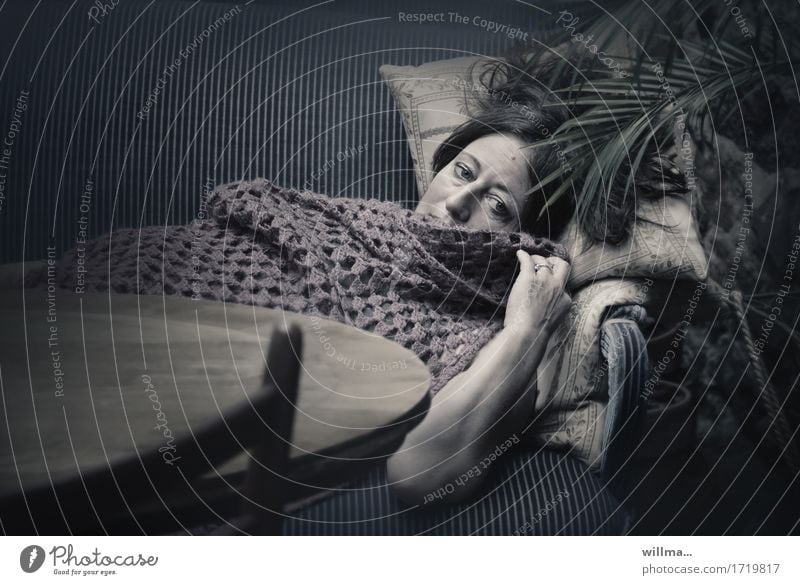 Sad woman lies melancholic on nostalgic sofa, covered with crocheted blanket Woman Adults Relaxation Lie Dark Fatigue Sofa Palm frond Sadness Dream Lady