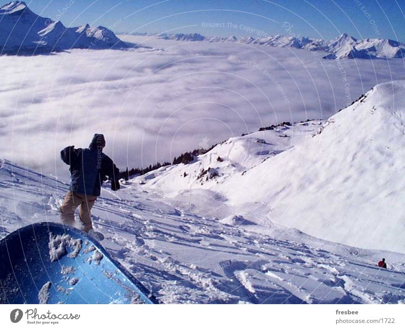 the ride Snowboard Sports Alps Snowboarding Snowboarder Deep snow Powder snow Above the clouds Cloud cover Valley Snowcapped peak Downward Tracks Snowscape