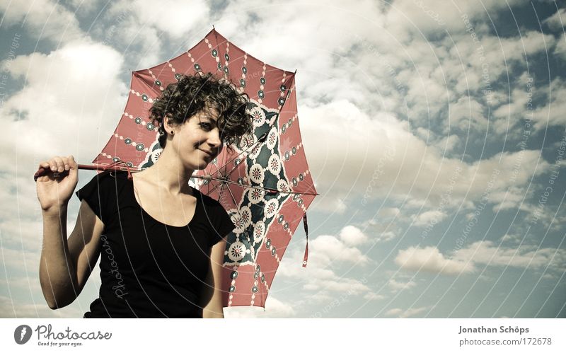 young woman in black points with umbrella to the right in front of a cloudy sky Lifestyle Elegant Style Joy luck already Contentment Senses Going out